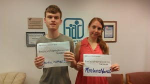 Photo of Tyler and Kristin of PYD holding up signs that read "#nonprofitsmakesense because... youth matter!" "#nonprofitsmakesense because...mentoring works!"