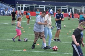 Dejan doing a soccer drill, with Nicole acting as human guide
