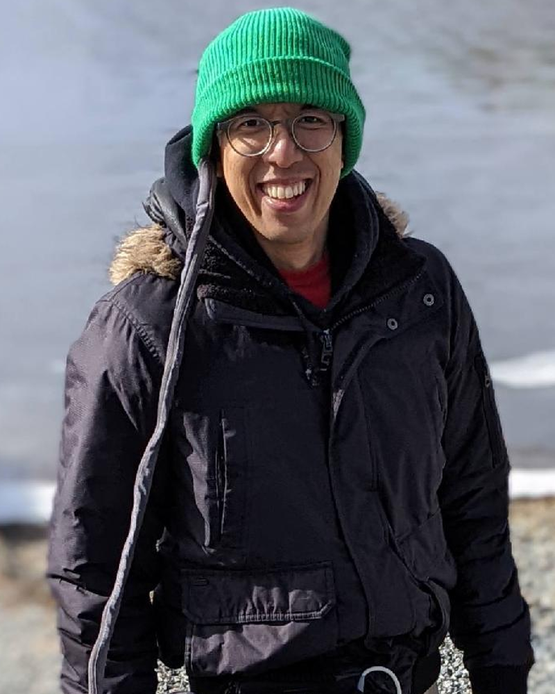 A man taking a walk with his Optune device to help with his condition.