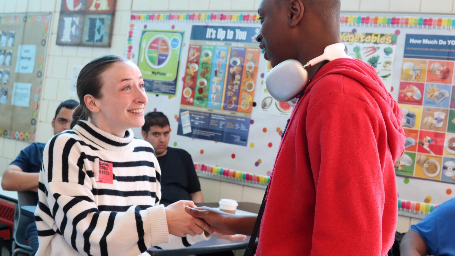A student and PYD staff member shake hands at a mock interview.