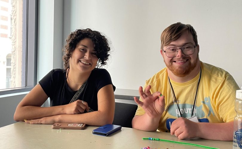 Annalise (left) sits next to a YLF participant (right)