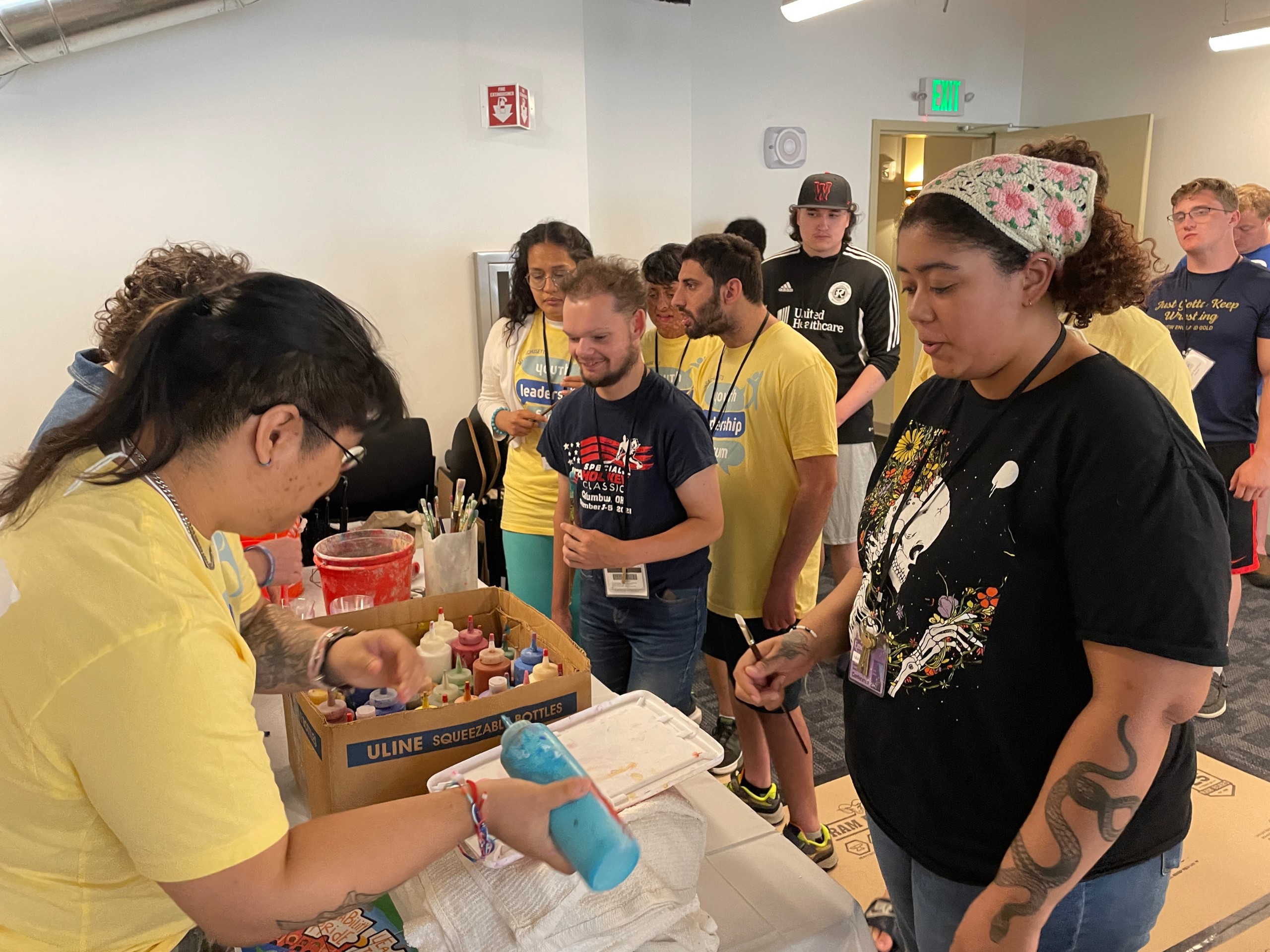 Participants of YLF work on an art projects with paint.