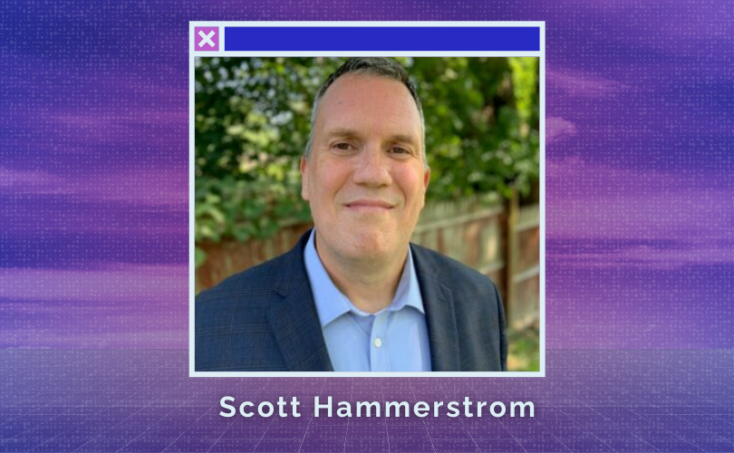 Standing outside by a fence with dark blue sport jacket and light blue dress shirt