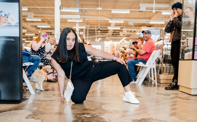 A PYD participant poses on the ground, showing her outfit off.