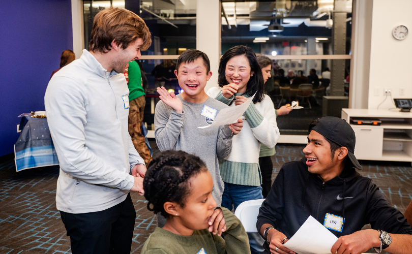 Honors Night attendees cheer and gather around a table.