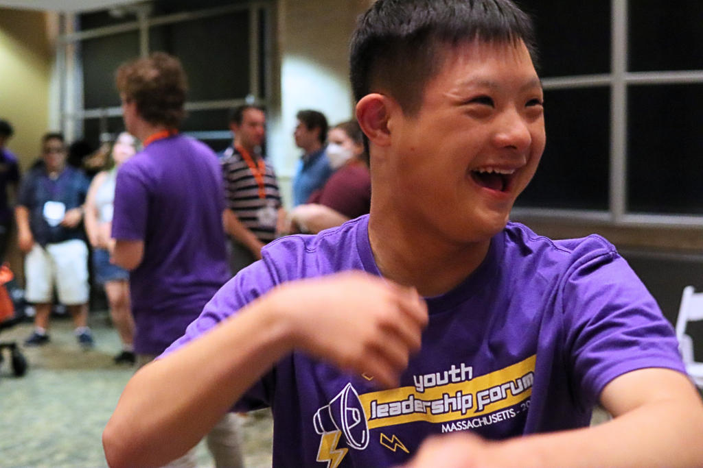 YLF participant is dancing and smiling.