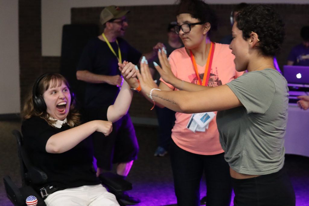 Three participants dance with each other during the YLF dance.